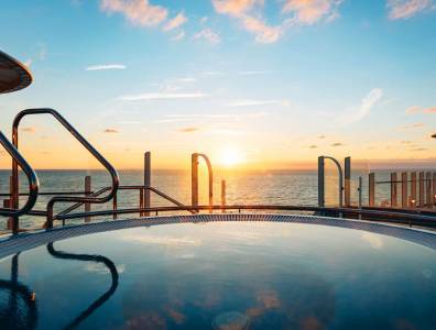 Whirlpool an Bord der AIDACosma mit Blick auf den Sonnenaufgang über dem Meer