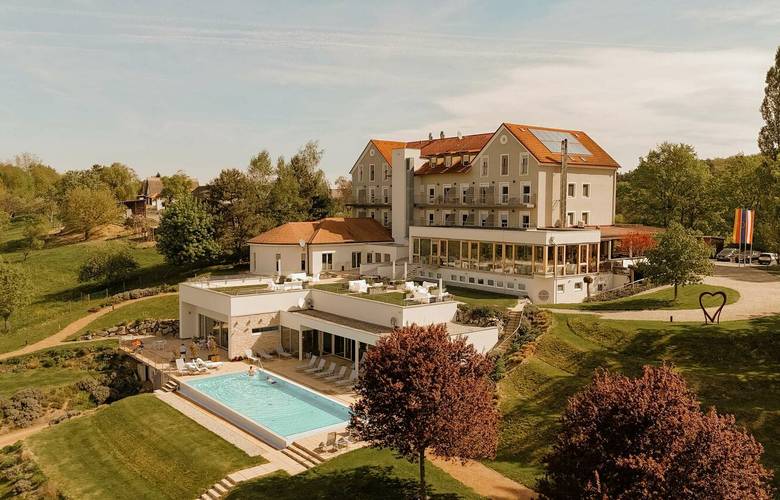 Seminarhotel Das Eisenberg mit Naturumgebung, Gartenlandschaft,  Panorama Außenpool und Blick über die sanften Hügel des Burgenlands